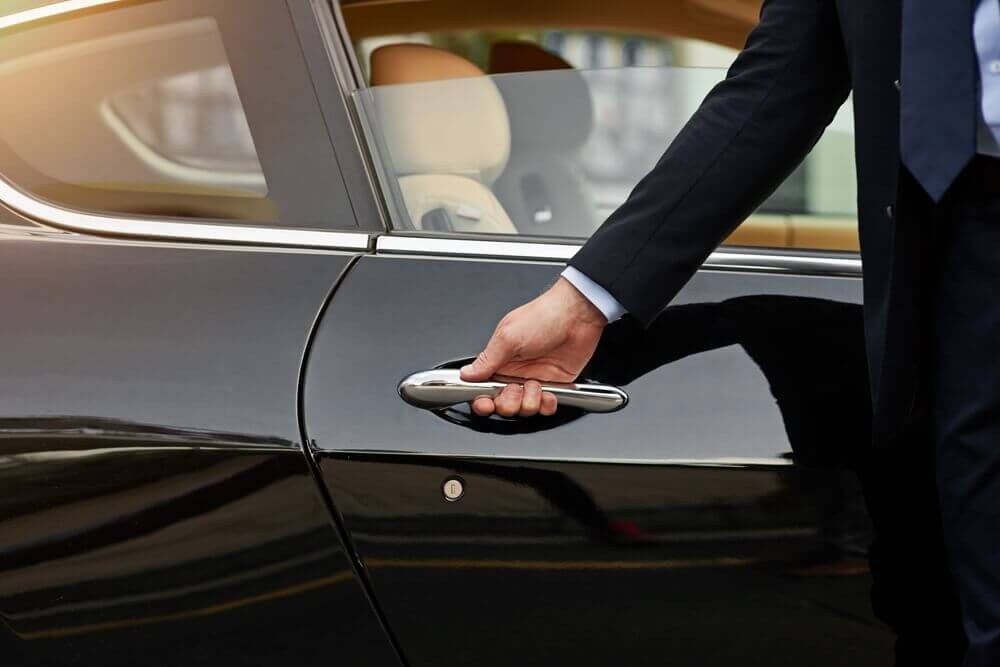 Professional chauffeur with a premium Mercedes F1 transfer