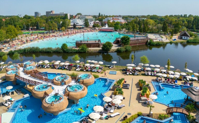Aerial view of Hajdúszoboszló aquapark, thermal pools, wave pool and beach complex beside the lake